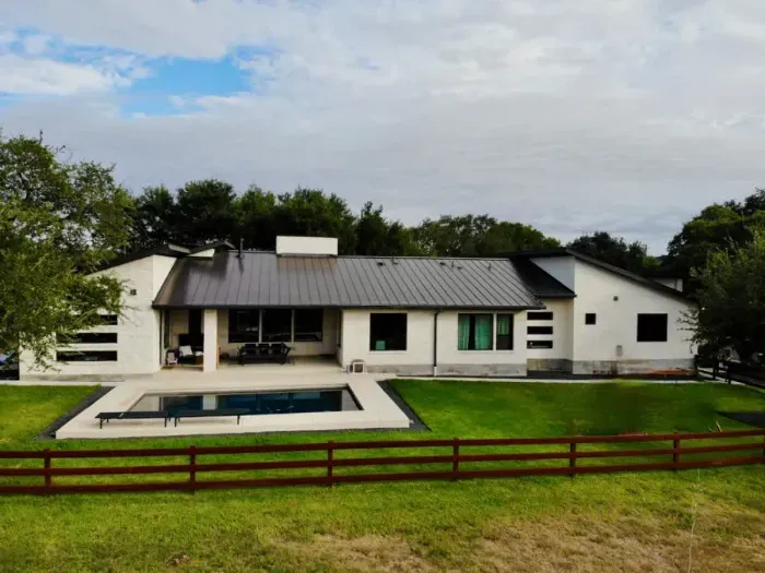 Spacious backyard with a lush lawn, perfect for outdoor games, relaxation, and barbecues.