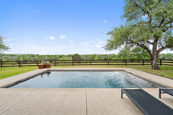 Gorgeous backyard with a sparkling pool, perfect for sunbathing and swimming.