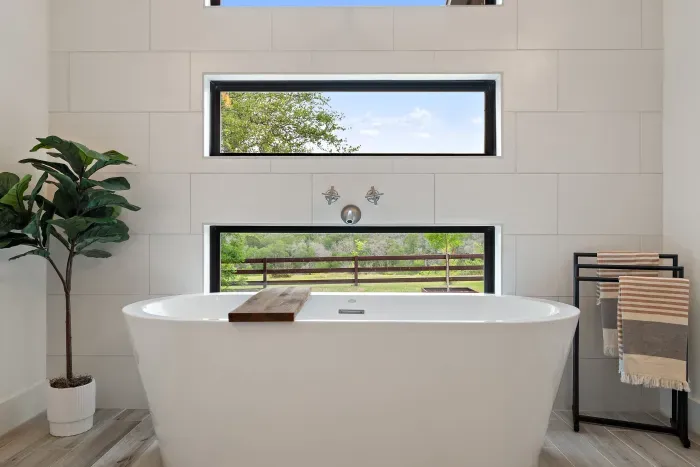 Primary Bathroom with views, soaking tub, walk-in shower, makeup vanity, and dual sinks.