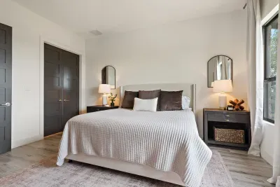 Spacious primary bedroom with a king-sized bed and an en-suite bathroom.