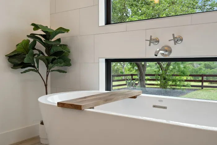 Soak and relax in the spa-like tub with tranquil outdoor views.