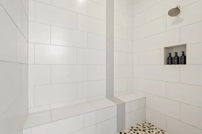Cozy bathroom with a walk-in shower and chic, minimalist design.