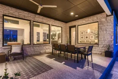 Spacious patio with a dining table and lounge chairs, ideal for outdoor meals and gatherings.