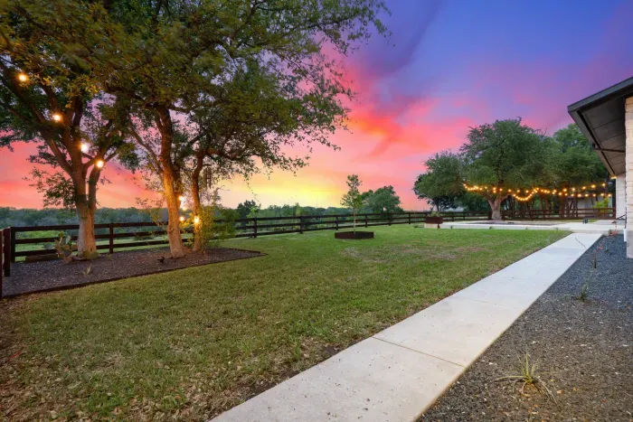 Beautifully landscaped backyard with a combination of greenery, flowers, and a peaceful atmosphere.