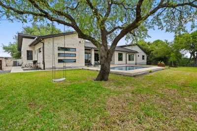 Well-maintained backyard with a variety of trees and shrubs for a natural, private setting.
