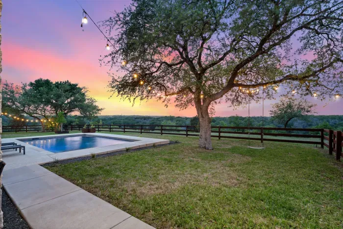 Well-maintained backyard with a variety of trees and shrubs for a natural, private setting.