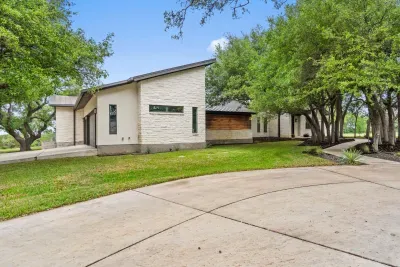 Spacious front yard with beautiful greenery and inviting entry.