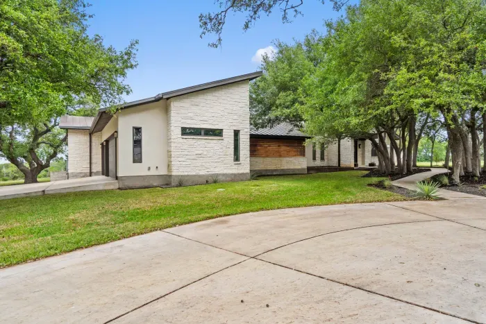 Spacious front yard with beautiful greenery and inviting entry.