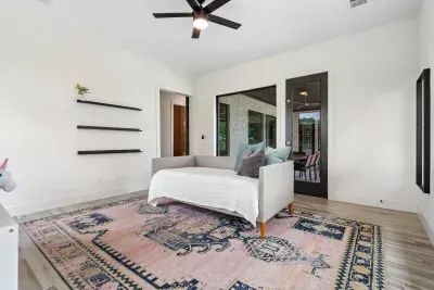 This playroom off the patio can be used as a family room, game room, or additional relaxation space. There is a daybed for you to snuggle up and enjoy a movie!