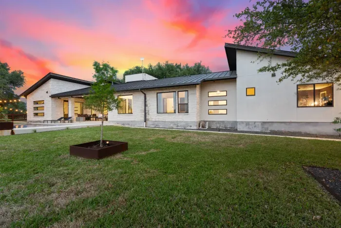 Relax by the private pool, complete with lounge chairs and shaded areas, offering a serene retreat in the backyard.