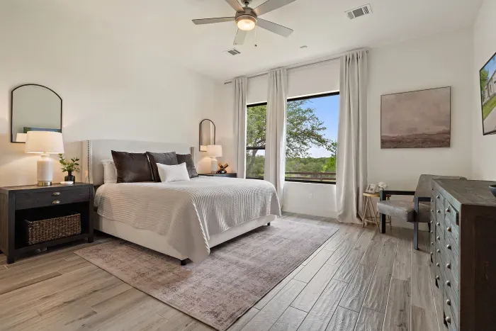 Spacious primary suite with natural light and serene landscapes.