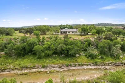 Nestled on the edge of the San Gabriel River, this home has room to run and views galore!