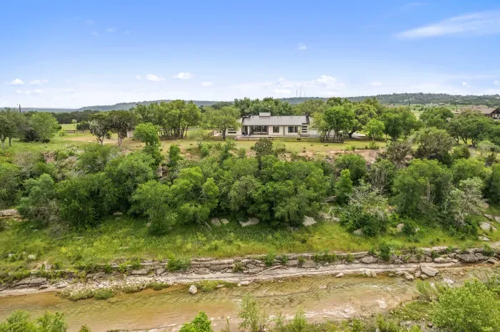 Nestled on the edge of the San Gabriel River, this home has room to run and views galore!