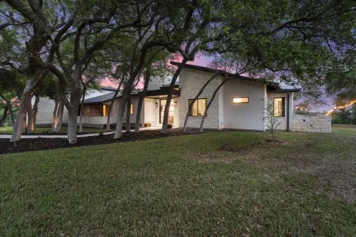 Charming exterior with shaded entry and Hill Country character.
