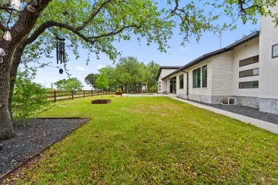 Well-maintained backyard with a variety of trees and shrubs for a natural, private setting.