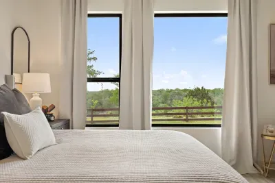Large primary suite with huge windows and great views.
