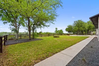 Beautifully landscaped backyard with a combination of greenery, flowers, and a peaceful atmosphere.