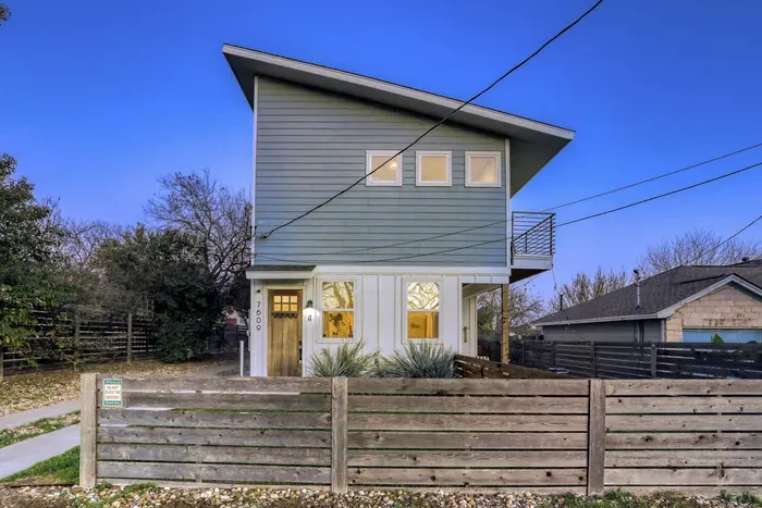 Clean architectural lines with fenced yard for added privacy.