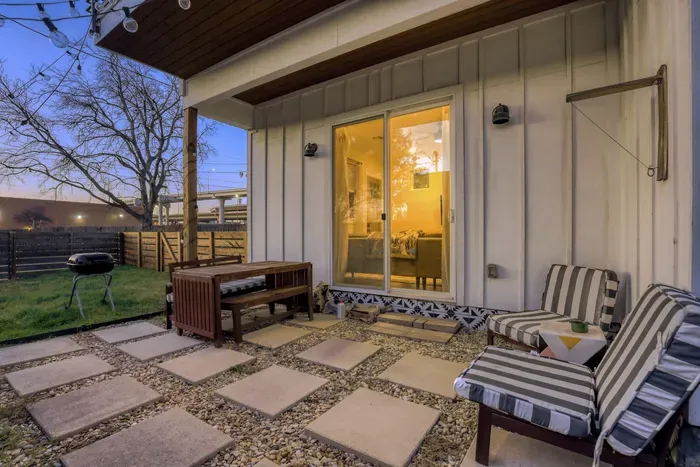 Comfortable seating and warm lighting for relaxing outdoors.