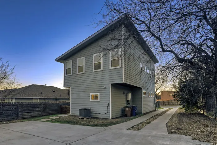 Modern two-story design with fenced outdoor areas for privacy.