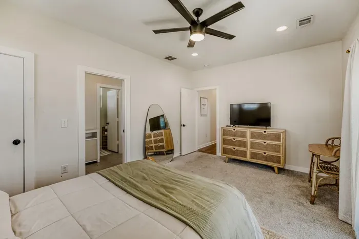 Calm, spacious bedroom with soft tones and relaxing ambiance.