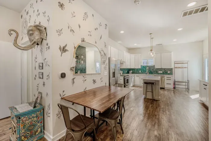 Stylish dining area flowing seamlessly into the kitchen and living room.