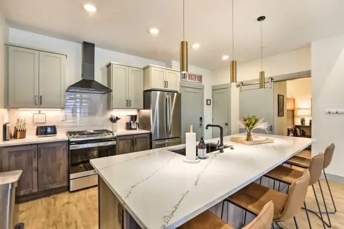 2. Functional and beautiful, this kitchen comes fully equipped with cookware, utensils, and small appliances.