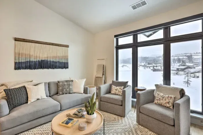 Spacious and bright living room with large windows and serene views.