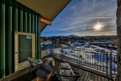 Covered balcony seating with winter mountain scenery.