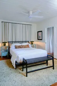 Guest bedroom with comfortable bed and soft lighting.