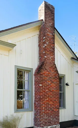 Historic brick chimney exterior.