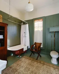 Bathroom with vintage clawfoot tub and classic details.