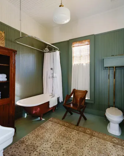 Bathroom with vintage clawfoot tub and classic details.