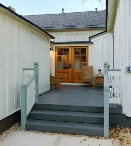 Private rear porch with seating and exterior entry.