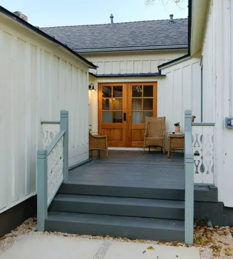 Private rear porch with seating and exterior entry.