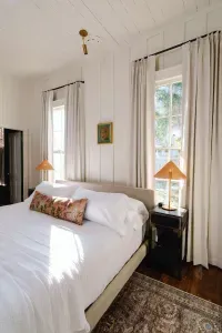 Primary bedroom with natural light and cozy linens.