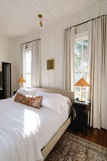 Primary bedroom with natural light and cozy linens.
