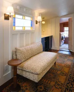 Cozy hallway seating with stained glass accents