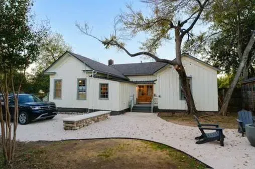 Charming cottage exterior with private yard.
