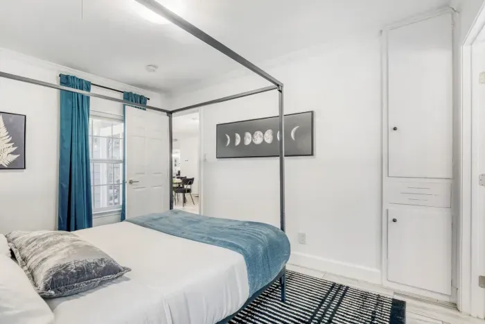 Spacious primary bedroom with modern décor and easy access to the ensuite bathroom