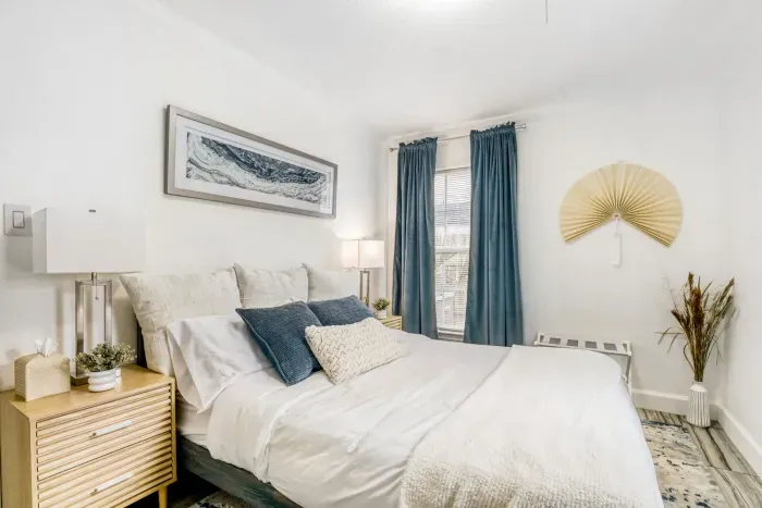 Comfortable guest bedroom with soft linens, natural light, and calming décor