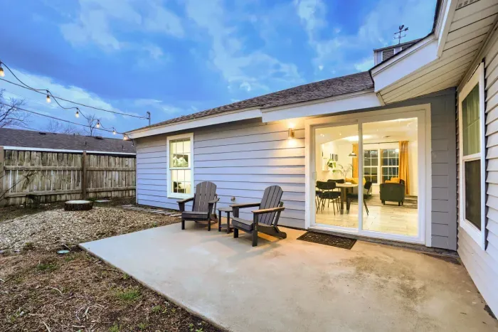 Back patio seating with sliding glass doors connecting the indoor dining space