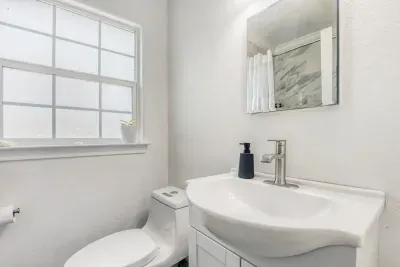 Updated primary bathroom with marble-style tile shower and modern finishes