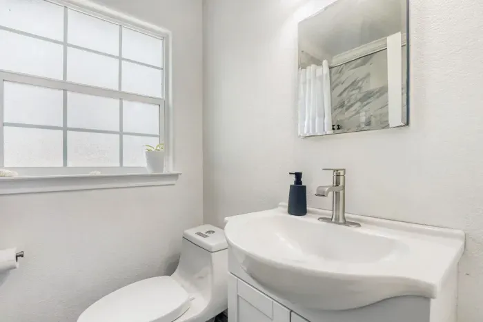 Updated primary bathroom with marble-style tile shower and modern finishes