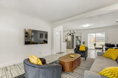 Bright living room with comfortable seating and a large wall-mounted TV