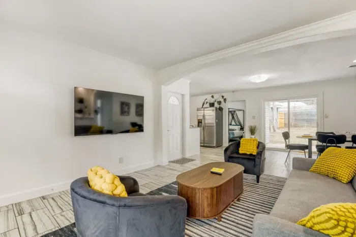 Bright living room with comfortable seating and a large wall-mounted TV