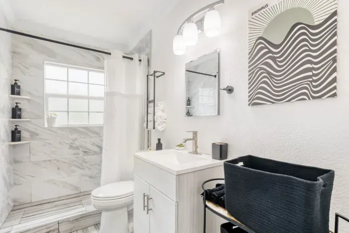 Clean and simple bathroom with fresh finishes and bright natural light.