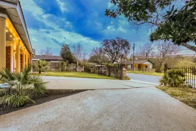 Spacious private driveway with easy parking and a welcoming front porch lit for evening arrivals.