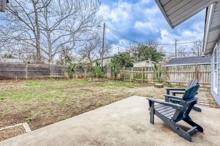 Private backyard patio with Adirondack seating, perfect for relaxing outdoors
