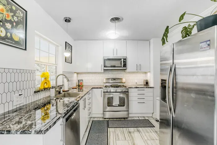 Fully equipped kitchen with stainless steel appliances and plenty of space to cook and gather
